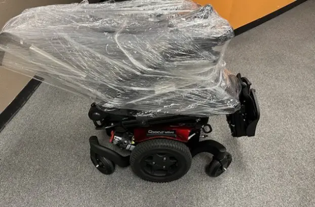 Power wheelchair wrapped in plastic